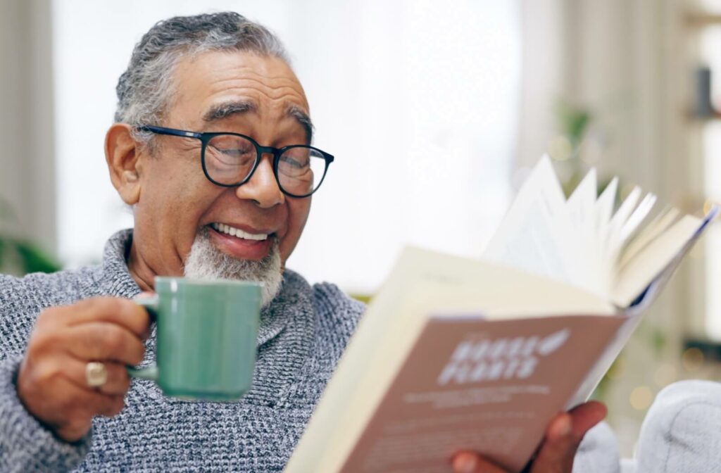 a senior drinks tea and reads a book